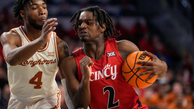 Cincinnati Bearcats guard Jizzle James (2) drives against Texas Longhorns guard Tyrese Hunter (4) in the second half of the NCAA Big 12 basketball game between the Cincinnati Bearcats and the Texas Longhorns at Fifth Third Arena in Cincinnati on Tuesday, Jan. 9, 2024. Texas pulled off a 74-73 win on a go-ahead basket in the final seconds of the game.